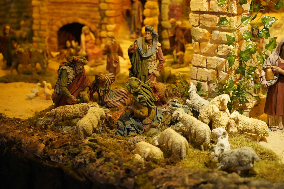 Painted miniature of shepherds and sheep.